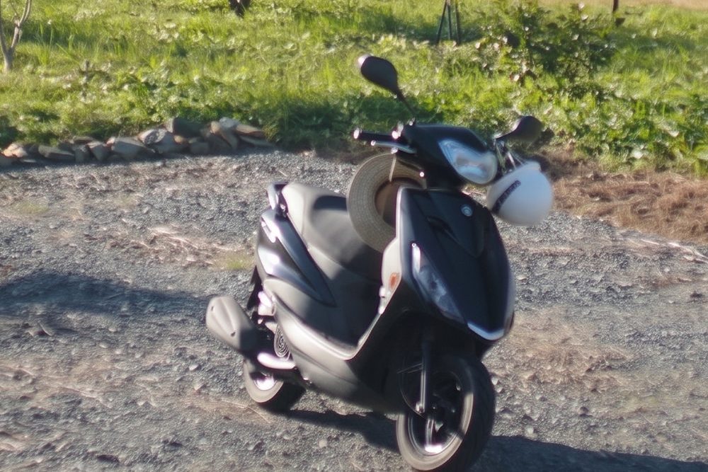 Enhanced out-of-focus photo of a parked scooter