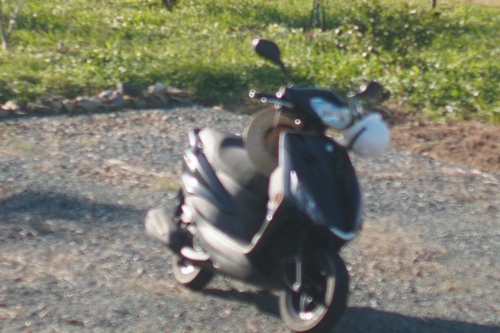Original out-of-focus photo of a parked scooter