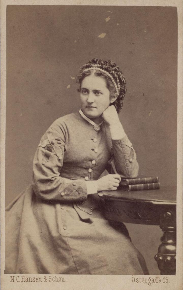 Original faded sepia studio portrait of a woman from the 1870s